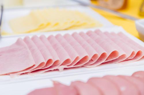 a stack of pink folded napkins on a table at Hotel Nova Aliança in Chapadão do Sul