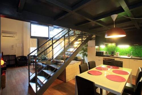 a dining room with a table and a staircase at Marina Loft & Apartments in Valencia