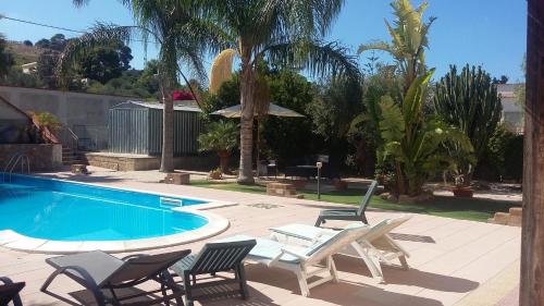 a patio with chairs and a swimming pool at B&B Castellazzo in Paceco