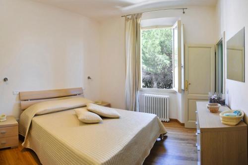 a bedroom with two beds and a window at Guerrini Hotel in Castiglioncello