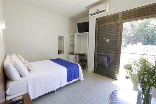 Säng eller sängar i ett rum på Hotel Porto do Sol