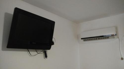 a flat screen tv hanging on a wall at Madryn Duplex in Puerto Madryn