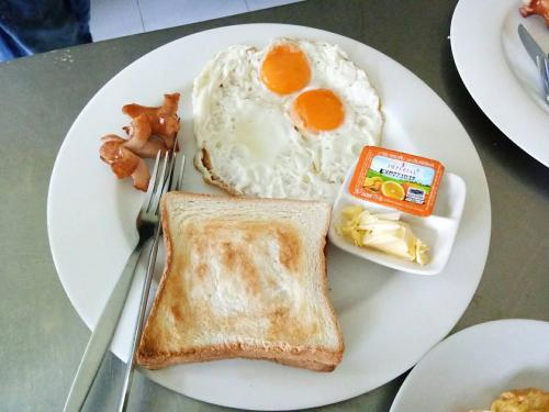 um prato de pequeno-almoço com ovos e torradas em Everest Resort Samui - SHA Plus em Mae Nam
