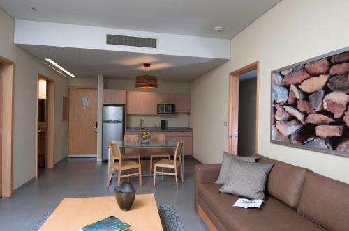 a living room with a couch and a table at Stadia Suites Mexico City Santa Fe in Mexico City