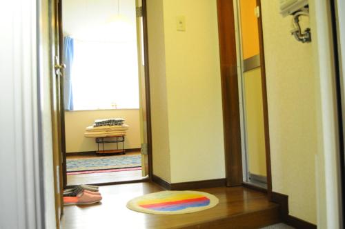 un pasillo con una alfombra colorida en el suelo en Petit Hotel Koizumi, en Lago Toya