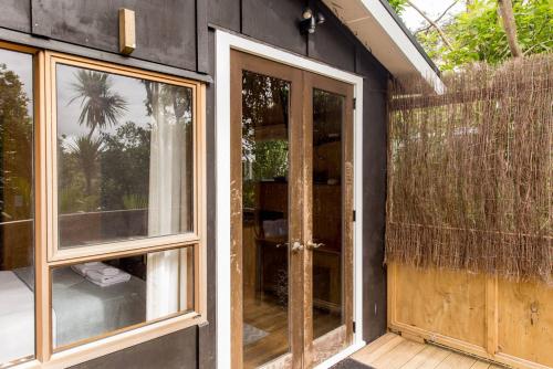 a house with sliding glass doors on the side of it at Palm Beach Bungalows in Palm Beach