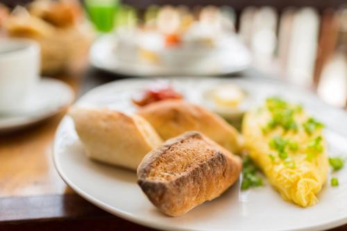 une assiette de nourriture avec du pain et des légumes sur une table dans l'établissement La Villa du Bonheur, à Siem Reap