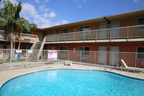 a large swimming pool in front of a building at Chateau Inn & Suites in Downey