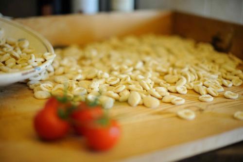 a cake with nuts on top of a table with tomatoes at Agriturismo Arco di Sole in Alberobello