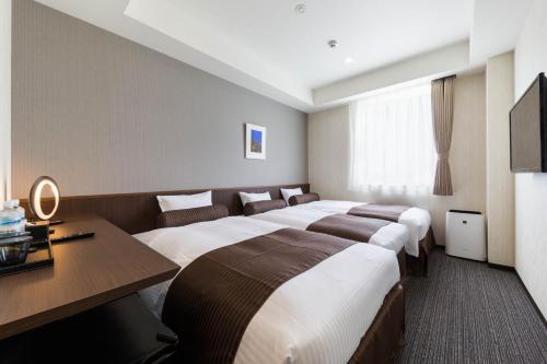 Säng eller sängar i ett rum på N Gate Hotel Osaka