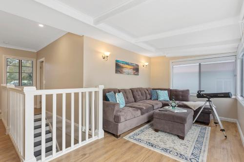 a living room with a couch and a table at Hamptons at The Bay in Deception Bay