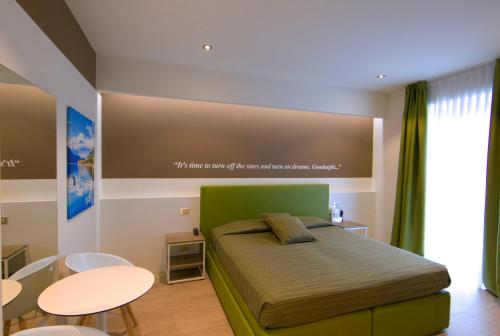 a bedroom with a bed with a large screen above it at Hotel Ideal in Sirmione