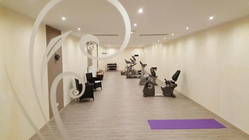 a fitness room with a row of exercise bikes at Hotelpark der Westerwald Treff in Oberlahr