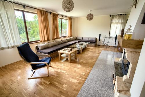 a living room with a couch and a table at Guest House Villa Bozhenitsa in Bozhenitsa