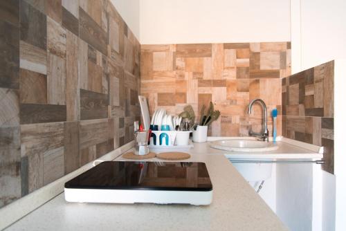 a kitchen with a tablet on a counter with a sink at Casa Vacanze Albora in Punta Secca