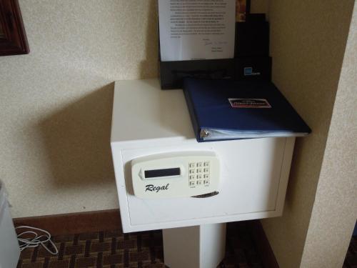 a white microwave with a box on top of it at Howard Johnson by Wyndham Virginia Beach in Virginia Beach