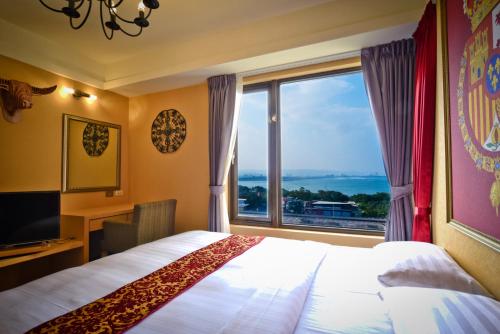 a hotel room with a bed and a large window at Sunrise Business Hotel - Tamsui in Tamsui