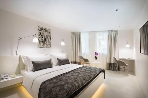 a hotel room with a bed and a desk at RIVALMARE Beach Boutique Hotel - NEW! in Novigrad Istria