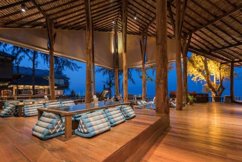 a pavilion with chairs and a table in the middle at Baan Ploy Sea in Ko Samed