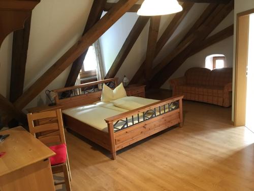 a bedroom with a large bed in a attic at Alter Pfarrhof in Wernberg-Köblitz
