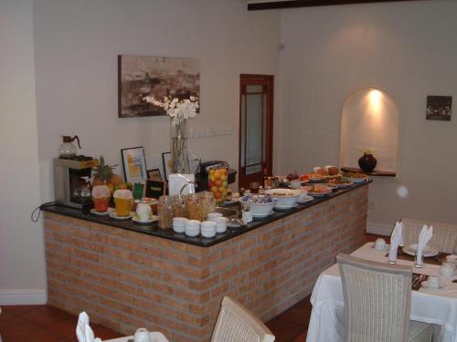 a buffet with food on top of a brick wall at Gable Manor by Neighbourgood in Franschhoek