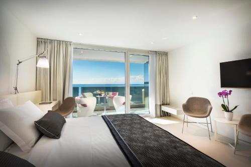 a bedroom with a bed with a view of the ocean at RIVALMARE Beach Boutique Hotel - NEW! in Novigrad Istria