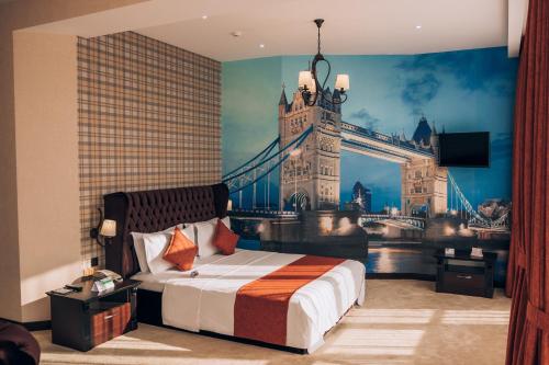 a bedroom with a mural of the tower bridge at Megapolis Hotel Shymkent in Shymkent