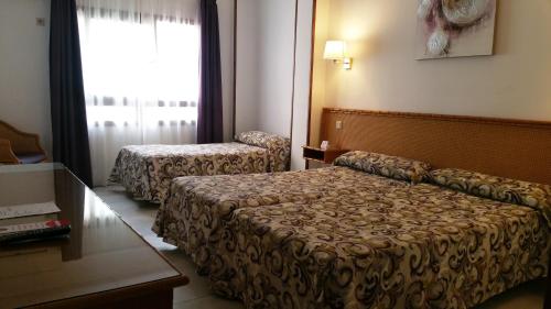 Säng eller sängar i ett rum på Hotel Las Rampas