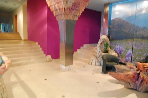 a room with stairs and a large column in the middle at Apartmán Šafran in Donovaly