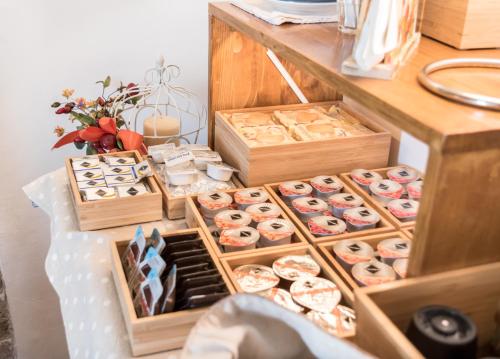 a display of different types of donuts in wooden boxes at B&B Cantico Delle Creature in Assisi