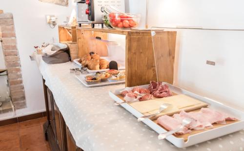 a counter with meat and other food items on it at B&B Cantico Delle Creature in Assisi