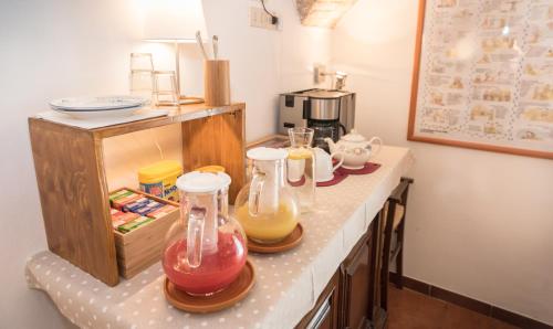 a kitchen counter with three glass jars on it at B&B Cantico Delle Creature in Assisi