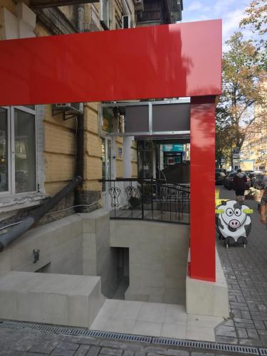 a red sculpture on a sidewalk in front of a building at Hostel Train Station in Kyiv