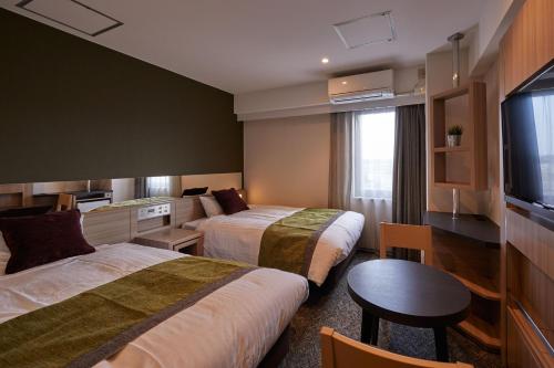 Säng eller sängar i ett rum på Fujinomiya Fujikyu Hotel