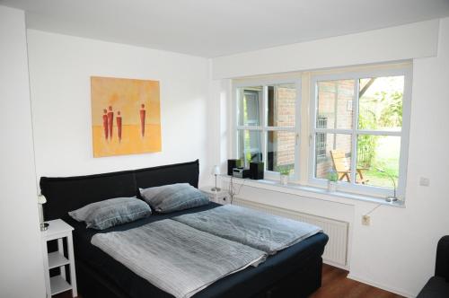 a bedroom with a bed and a window at Aaltine 3 in Bad Bentheim
