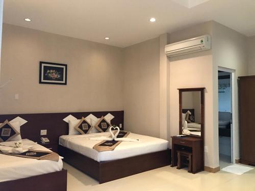 En eller flere senge i et værelse på Mui Ne Volga Hotel & Apartments