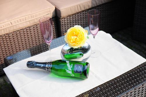 a table with a bottle of wine and two glasses at Aaltine 3 in Bad Bentheim