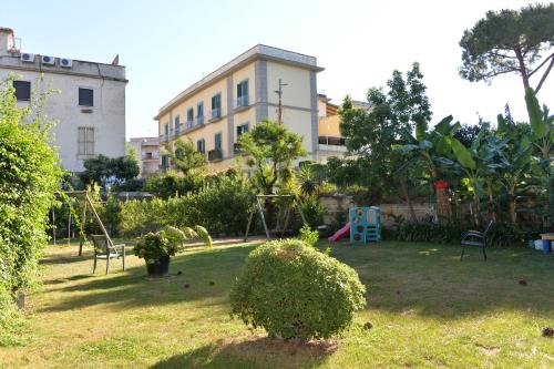 a yard with a playground in front of a building at Miramare Residence in Pozzuoli