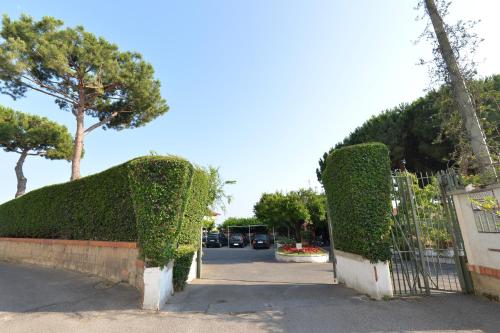 a gate with hedges next to a street at Miramare Residence in Pozzuoli