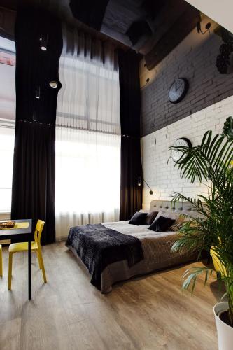 a bedroom with a large bed and a brick wall at Old Town Trio Apartments in Vilnius