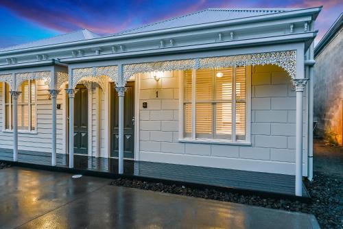 a white house with a lot of windows at Aloha Central Luxury Apartments in Mount Gambier