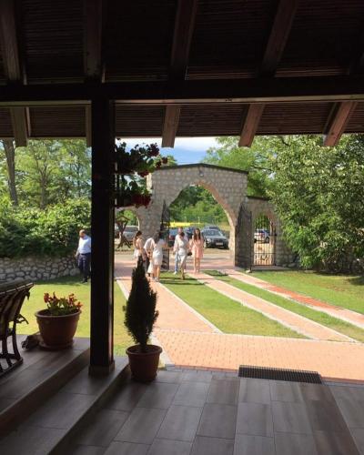 a group of people walking in a park at ATOS Srebrno jezero - Villa and Restaurant in Veliko Gradište