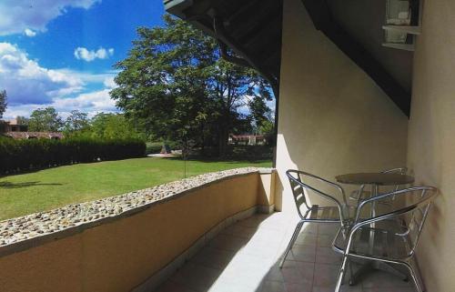 a patio with two chairs and a table on a wall at ATOS Srebrno jezero - Villa and Restaurant in Veliko Gradište