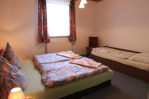 a bedroom with two beds and a window at Apartments Rügen Patzig in Patzig