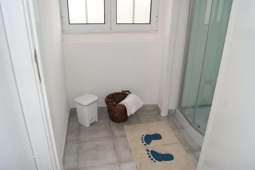 a bathroom with a shower and a toilet and a window at Azores Dream Hostel in Ponta Delgada