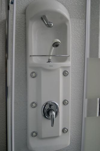 a sink in a bathroom with a faucet at Azores Dream Hostel in Ponta Delgada