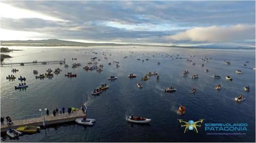 a group of boats in the water near a dock at Tierras Blancas Nihuil in El Nihuil