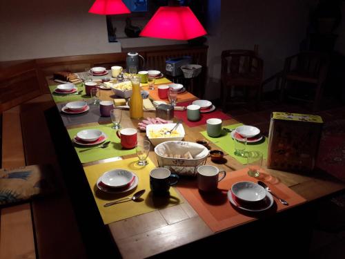 a table with plates and utensils on it at Casa Arnera in Andon