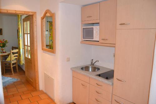 a kitchen with a sink and a microwave at Hotel Gerberhaus in Rothenburg ob der Tauber