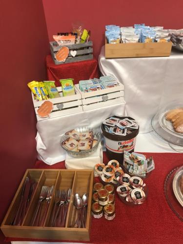 a table with a box of donuts and other food at Hotel Ascot in Caianello